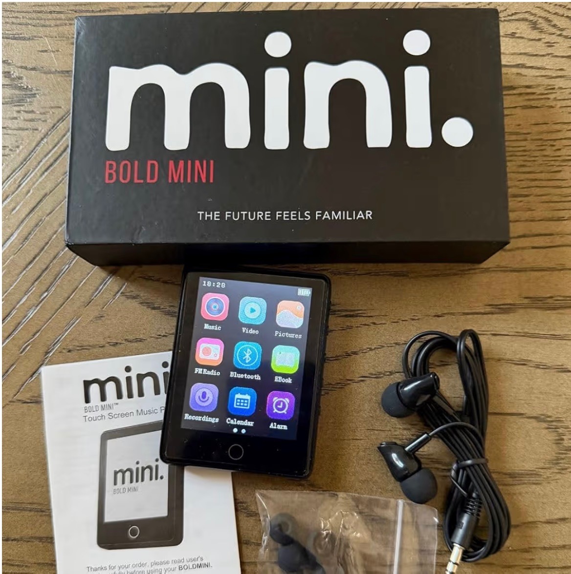 The Bold Mini touch-screen music player shown with its box, quick-start guide and earbuds