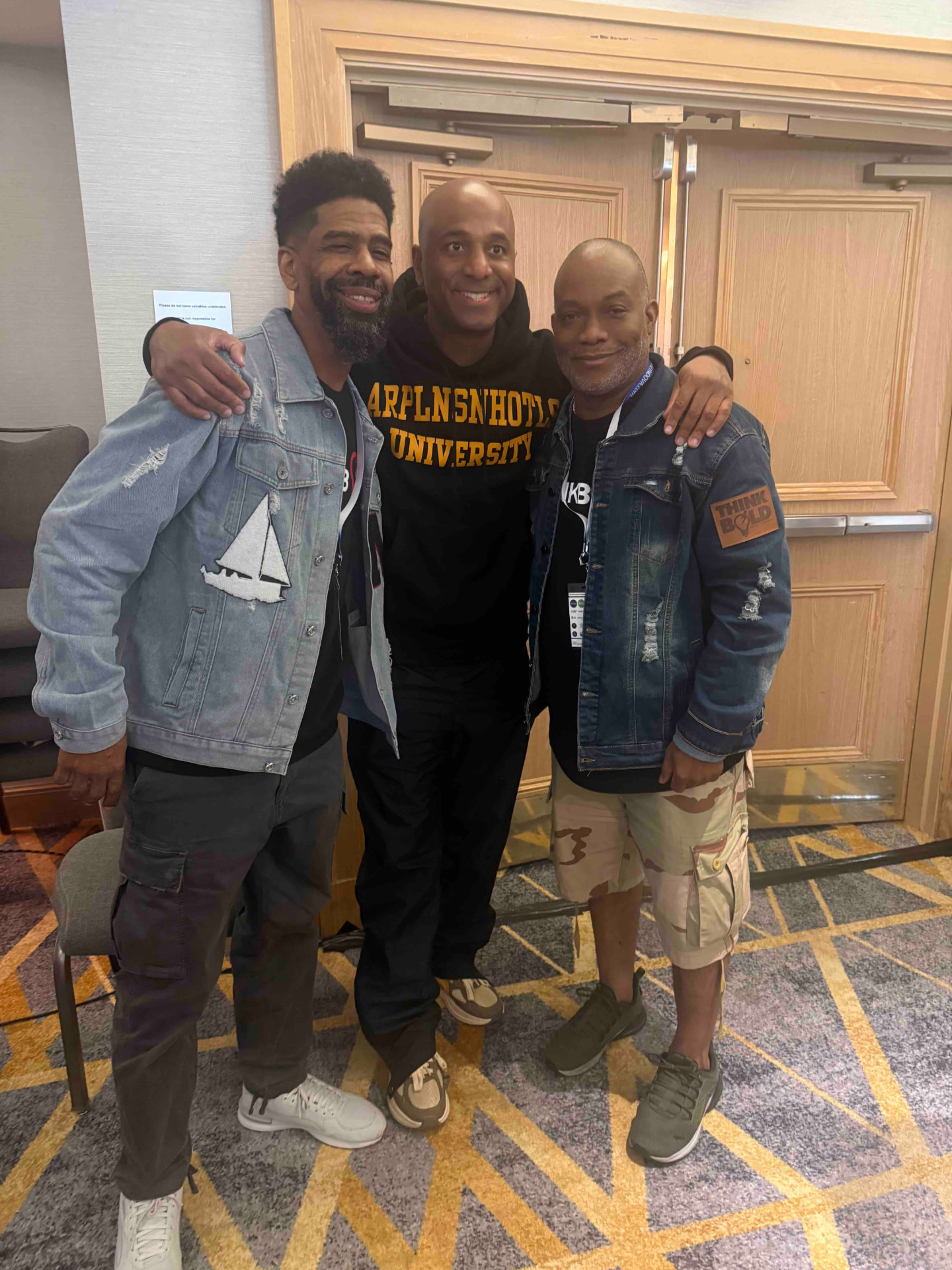 Troy and Mo with a guest between sessions at the Think Bold Festival, all in denim and Think Bold patches