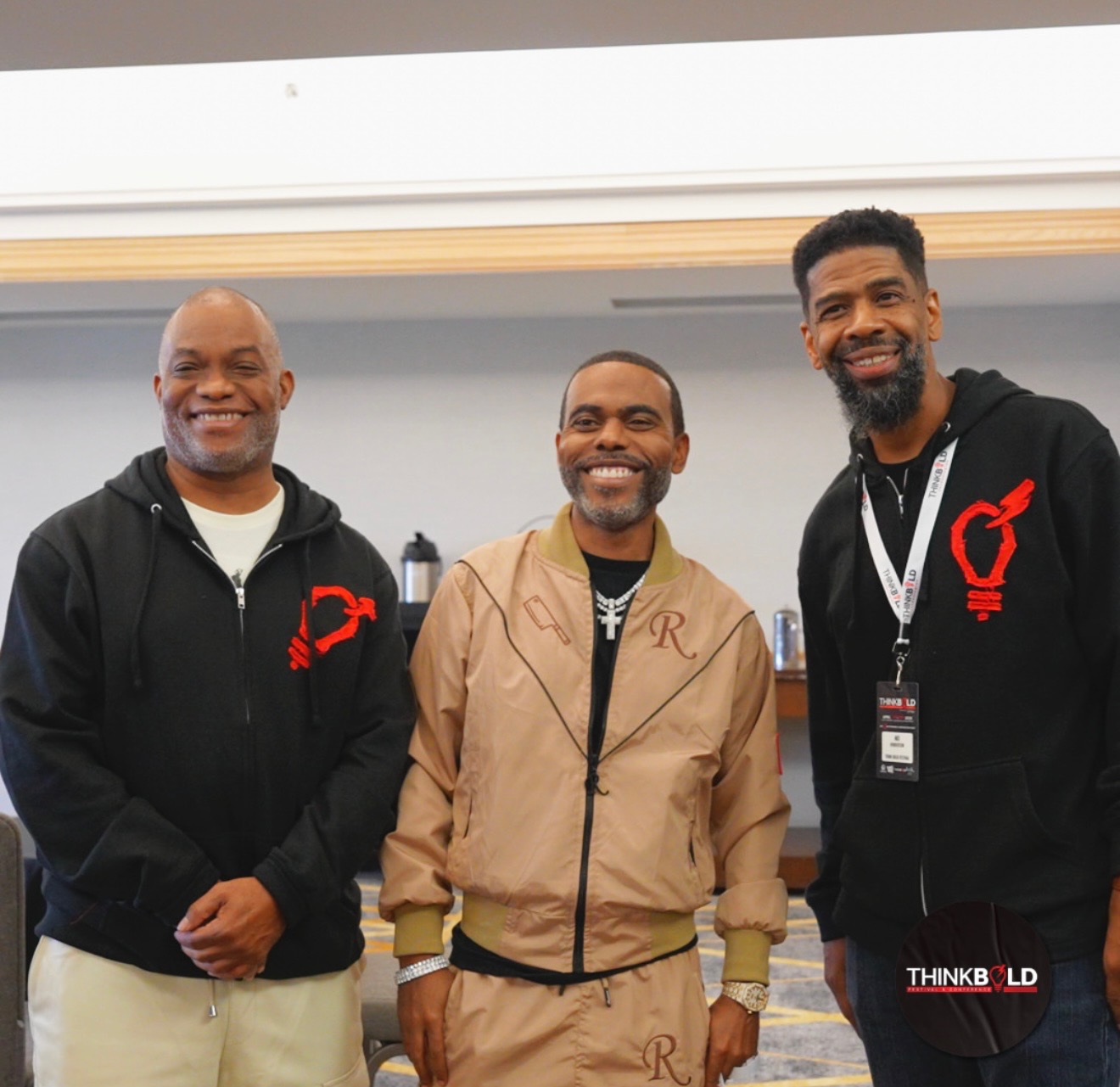Troy, Mo and a guest smiling together inside the Think Bold Festival & Conference