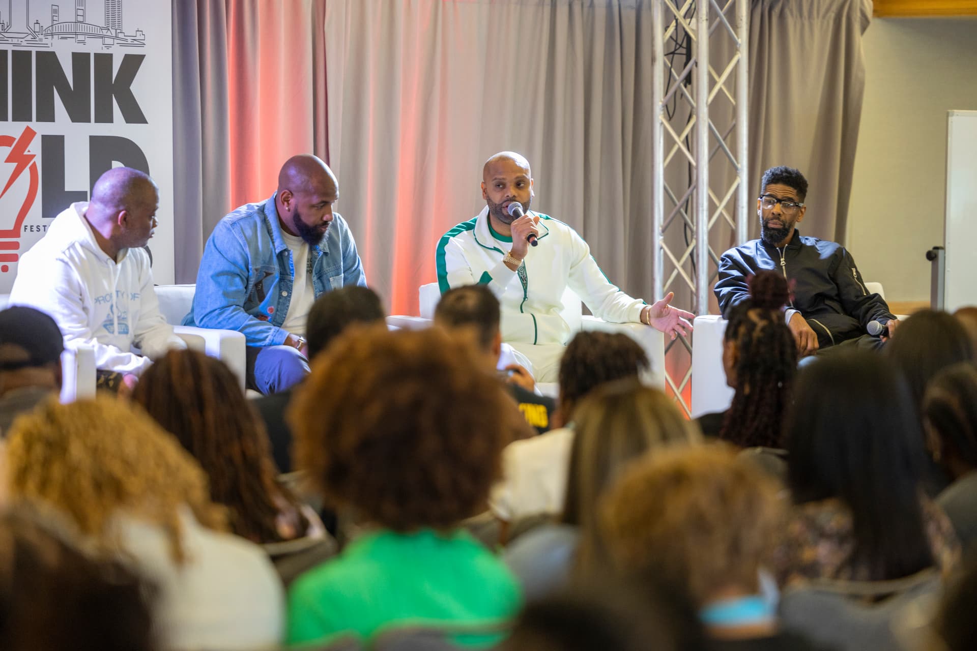 A packed Think Bold panel with a full seated audience